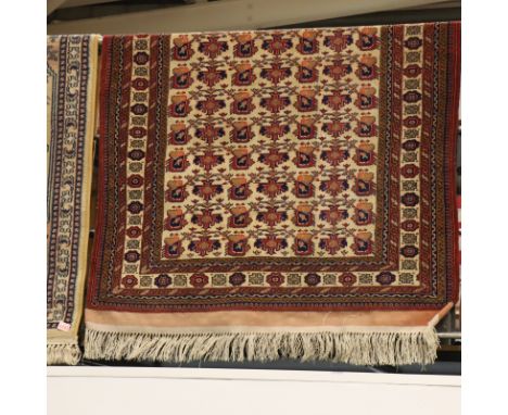 Middle Eastern fringed carpet, cream ground with designs in red and blue, 170 x 120cm. P&amp;P Group 3 (£25+VAT for the first