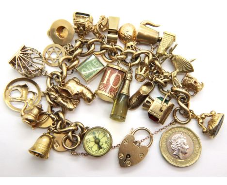 9ct gold charm bracelet with 25 charms including compass and spinning fob. 78.6g. P&amp;P Group 1 (£14+VAT for the first lot 