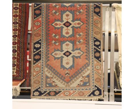 Middle Eastern fringed carpet, cream ground with designs in red and blue. P&amp;P Group 3 (£25+VAT for the first lot and £5+V