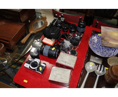 A quantity of cameras including Nikon F80, Nikon Coolpix, lenses and four boxes of Magic Lantern plates