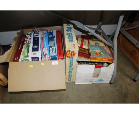 A box of puzzles, unknown if complete, a Mousetrap game and a box of vintage games and cards