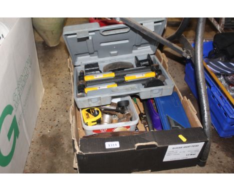 A box containing various tools to include an adjustable wrench, three various hammers in fitted plastic case, various sockets