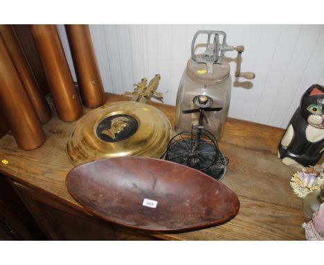 A glass blown hand operated butter churn, butter dish, wooden dish, candle stand of a penny farthing bicycle, bar shield and 