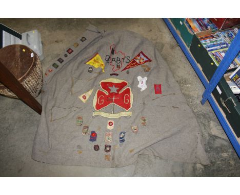 A quantity of vintage Girl Guide patches stitched onto a blanket