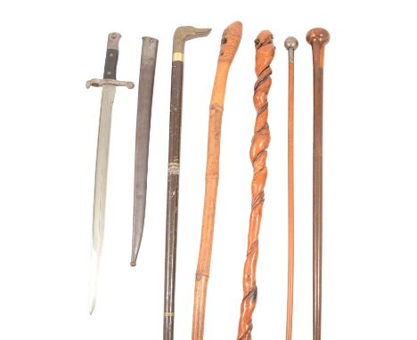 Collection of four walking sticks, a swagger stick with white metal finial '45th Rattray's Sikhs', 75cm, and a Steyr 1886 mod