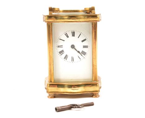 French brass carriage clock, serpentine case, white enamel diam with Roman numerals, 12.5cm.