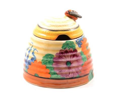 A Clarice Cliff Bizarre preserve/honey pot and cover in the Gayday pattern, Newport Pottery circa 1930, 10cm.Condition report