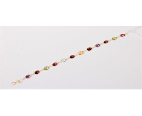 A 14ct m ulti gem set bracelet, comprised of oval amethyst, garnet, peridot, topaz and citrine, all spectacle set with shephe