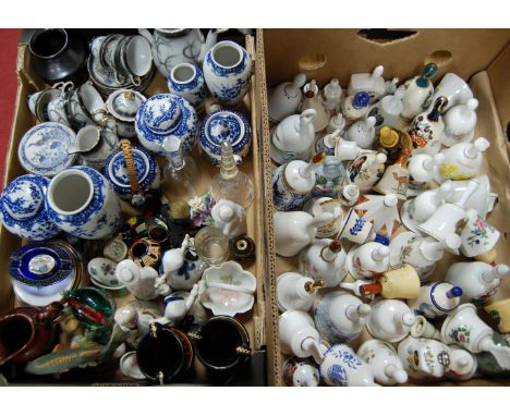 Two boxes containing a quantity of collectable china and figurines, to include ceramic bells, blue and white reproduction Chi