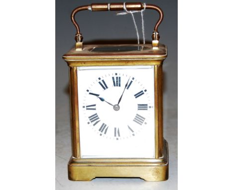 An early 20th century lacquered brass cased carriage clock having enamelled dial with Roman numerals and visible platform lev