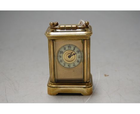 A miniature lacquered brass cased carriage clock having enamelled chapter ring and visible platform lever escapement, height 