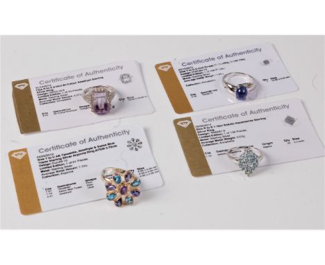 A silver and aquamarine cluster ring, size R, a silver tanzanite cabochon ring, size T, a silver tanzanite, amethyst and topa