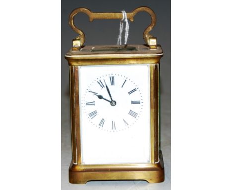 An mid 20th century lacquered brass cased carriage clock having enamelled dial with Roman numerals and visible platform lever