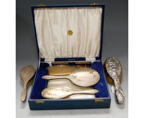 A cased engine turned silver four-piece dressing table set, comprising hairbrush, hand mirror, clothes brush and comb; togeth