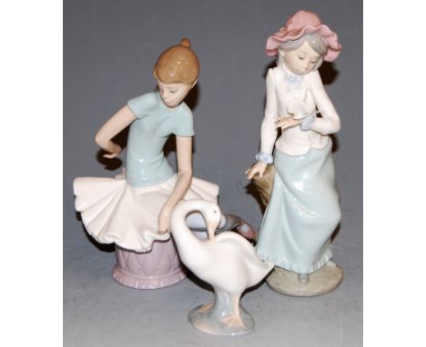 A Lladro figure of a ballerina in seated pose, having printed mark verso, h.2cm; together with a Nao figure of a girl with do