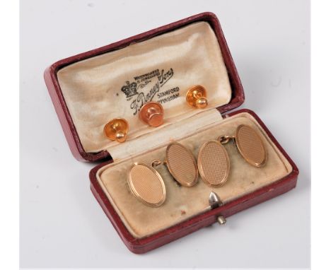 A pair of 9ct oval engine cufflinks, cased, together with a single 9ct collar stud (8.4g gross) and a pair of rolled gold col