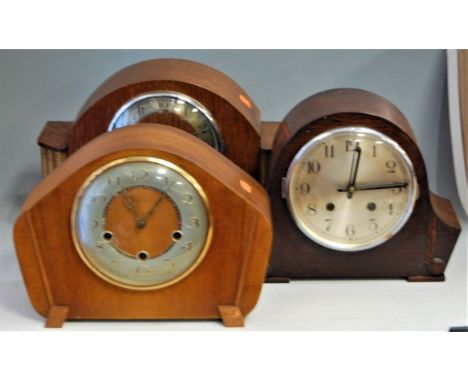 An Art Deco oak cased mantel clock, having silvered chapter ring with Arabic numerals and chiming movement; together with two