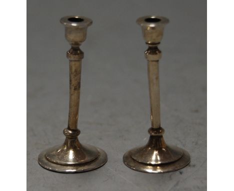 A pair of late Victorian silver miniature candlesticks by William Comyns, London 1891, height 4cm
