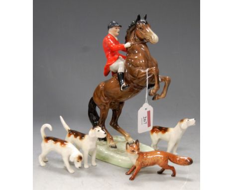 A Beswick hunting set, comprising rearing horse with huntsman, three hounds (one with tail re-stuck), and fox