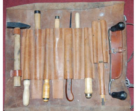 A leather carpenter's tool bag and contents