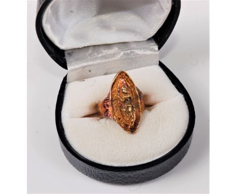 A marquise shaped ring, modelled with an Eastern figure, tapered shoulders and textured band stamped 750, size M, (6.5g)