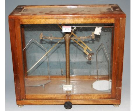 A set of brass laboratory scales in oak case, bearing label for WBM Glasgow, width 42cm