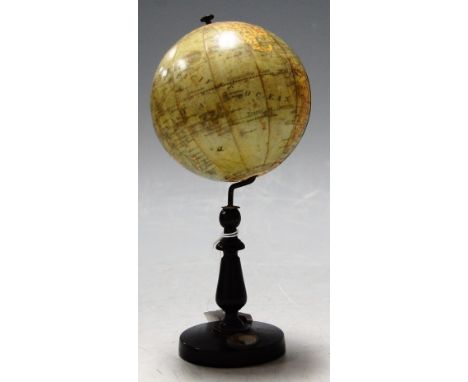 A circa 1910 Bavarian celestial table top globe dia. 10cm on turned ebonised stand with integral compass, height 20cmConditio