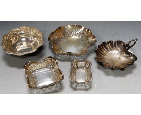 A white metal embossed bonbon dish, stamped Silver; a Mappin &amp; Webb shell shaped bonbon dish; and three various pierced b