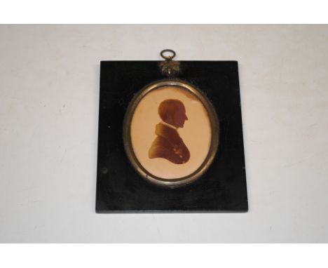 A portrait miniature signed and dated 1821, contained in an ebonised frame
