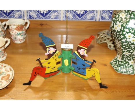 A vintage painted metal stand decorated with elves