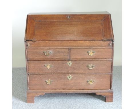A George III oak bureau, on bracket feet, 98cm