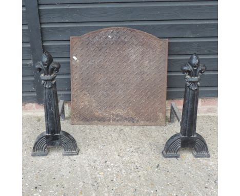 A pair of 19th century fire dogs, together with a fire back, a copper coal scuttle and fire tools