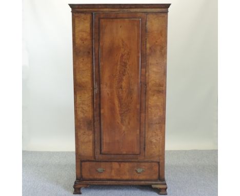 An early 20th century walnut single wardrobe, on bracket feet, 91cm