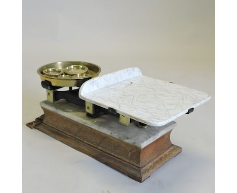 A set of early 20th century continental marble and brass mounted scales and weights, 63cm wide