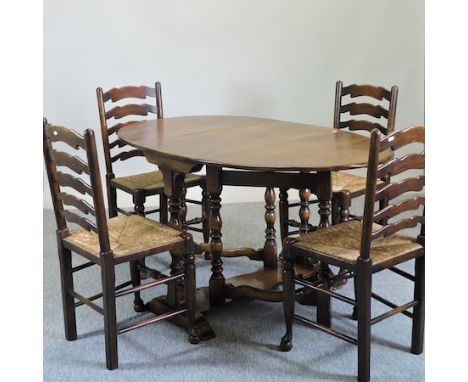 An oak drop leaf dining table, 91cm, together with a set of four rush seated ladder back dining chairs 