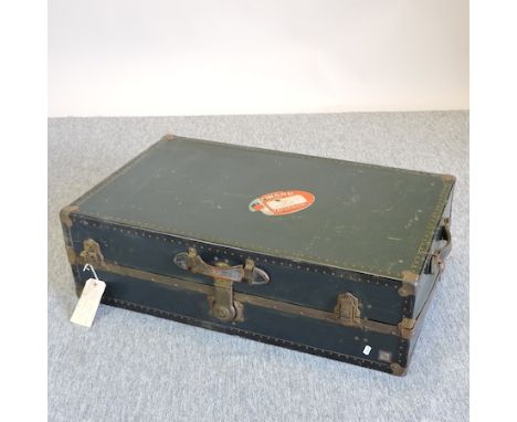 An early 20th century iron bound cabin trunk, with a fitted interior, bearing a label for Cunard Line, 88cm