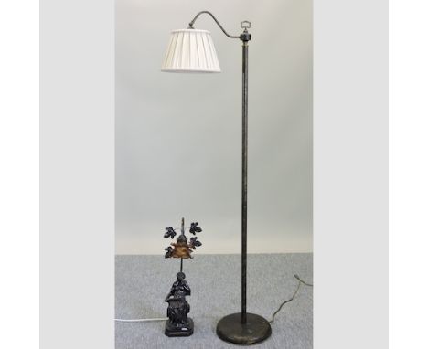 An iron standard lamp, 144cm tall, together with a figural table lamp 