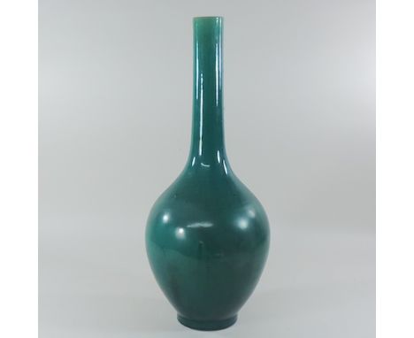 A late 19th century turquoise glazed pottery bottle vase, of Linthorpe style, 57cm tall 