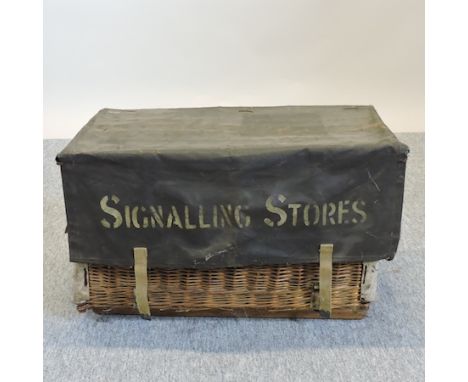 A wicker and metal mounted trunk, inscribed Signalling Stores, 85cm, together with two tin helmets