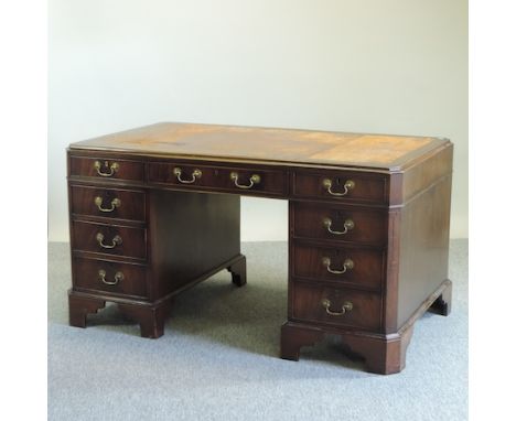 A reproduction mahogany pedestal desk, on bracket feet, 155cm