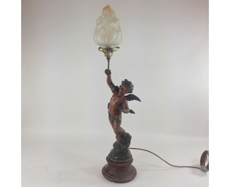 A 19th century spelter figural cherub table lamp, with a glass shade, 81cm tall overall