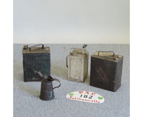 A collection of three vintage metal petrol cans, to include BP, 33cm tall, together with a metal sign and a jug 