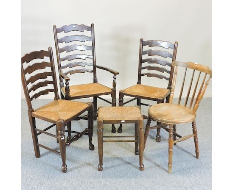 A ladder back open armchair, together with two ladder back dining chairs, a chair and a foot stool 