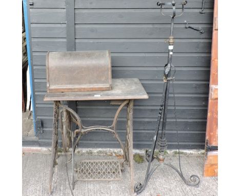 A Victorian sewing machine on an iron base, 71cm, together with an iron standard lamp 