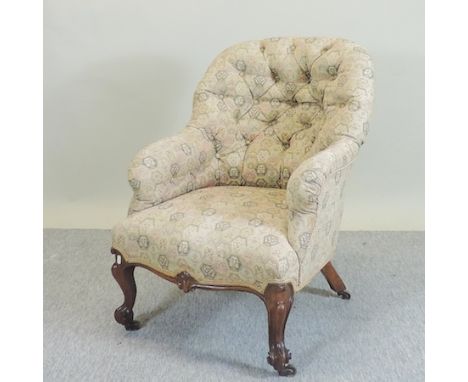 A Victorian cream upholstered button back armchair 