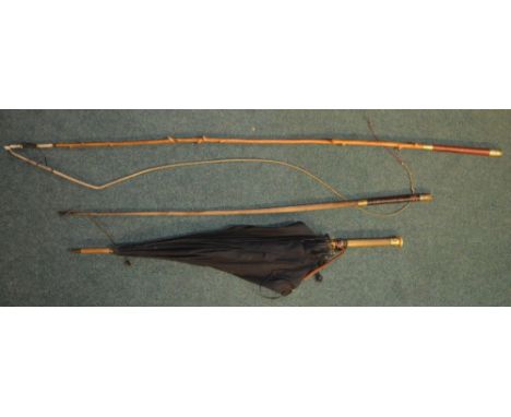 2 coachman's riding crops and an umbrella with gold handle base. 