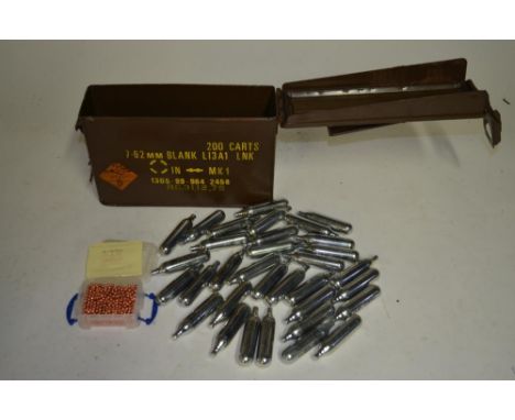 A collection of 12g CO2 capsules for air guns, an ammunition box for 7.62 blank rounds and a small box of 4.4mm metal copper 