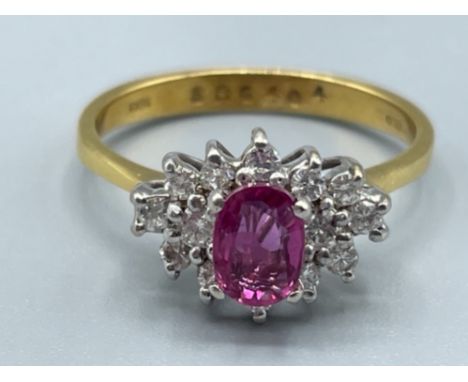 Ladies 18ct gold Ruby and Diamond cluster ring. Featuring a Oval shaped Ruby surrounded by 14 round brilliant cut diamonds. S