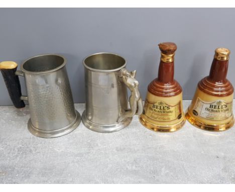 Pair of english pewter tankards with horn and nude lady handles together with a pair of Bells old scotch whisky decanters, 1 