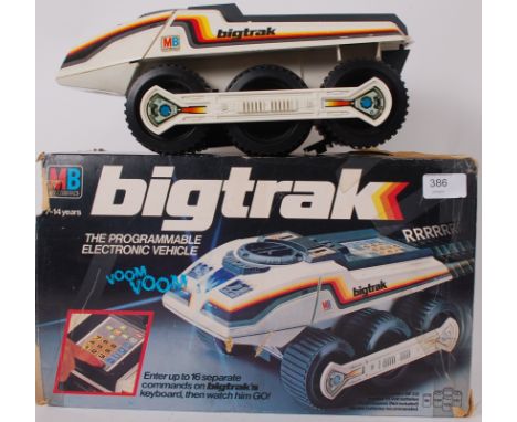 BIG TRAK; An original vintage MB Electronics Big Trak vehicle within the original box, along with another loose and a trailer